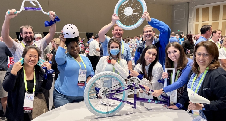 group of people assembling child's bike