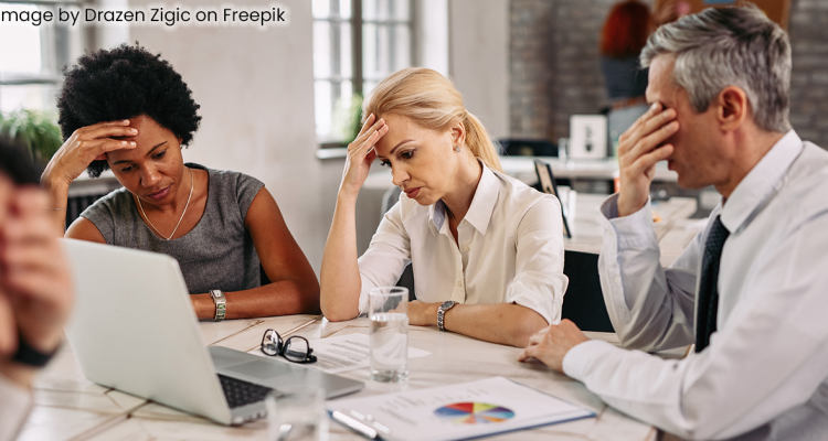 Frustrated Business Team Sitting Around Table