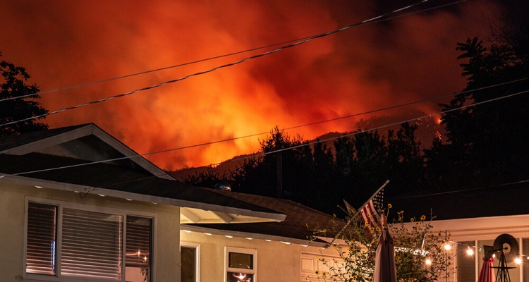 fire raging above houses