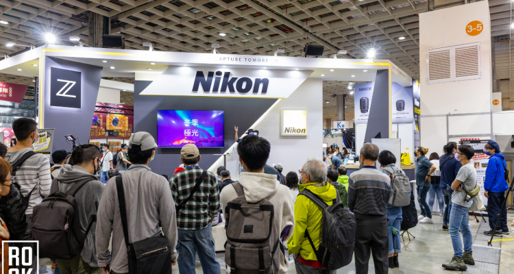 Trade Show Attendees Gathering At The Nikon Trade Show Booth