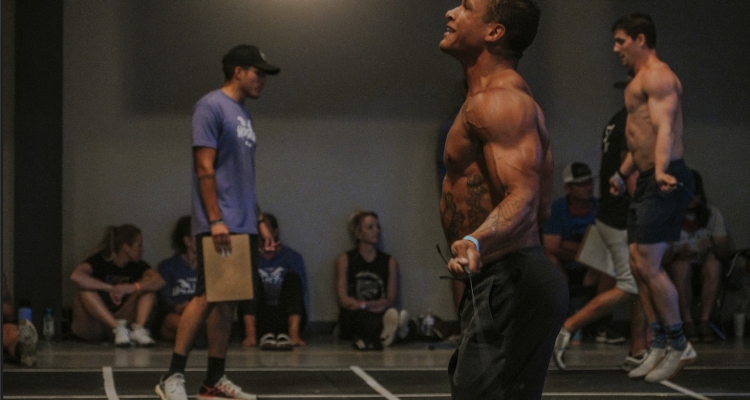 Two men compete in cross-fit tests.