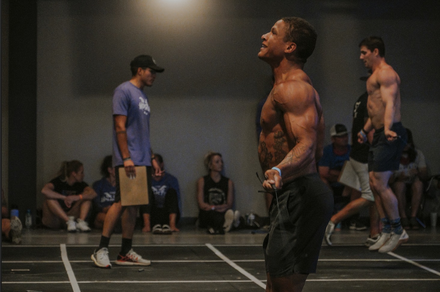 Two men compete in cross-fit tests.