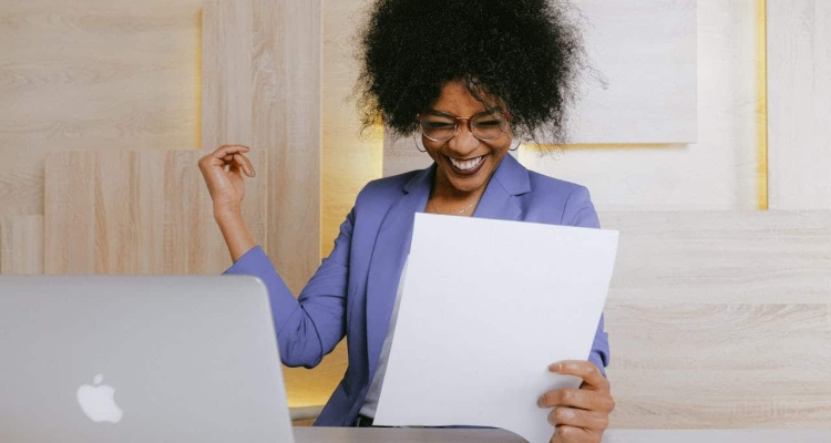 Photo by Anna Shvets: https://www.pexels.com/photo/woman-holding-a-paper-3727463/ -- win, land sponsor