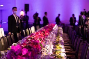 The table is covered with pink flowers and salad