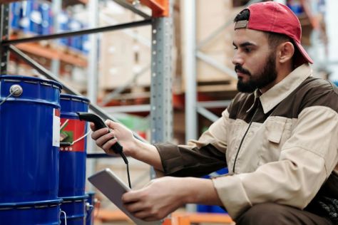 A man checks the temperature of products in a warehouse