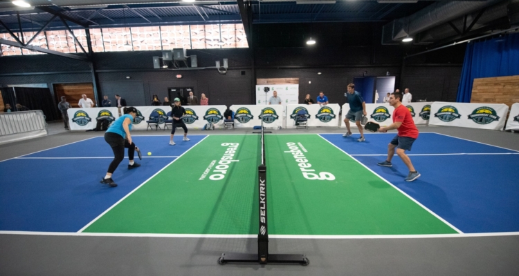 Four people playing a game of pickleball at the new indoor court in Greensboro