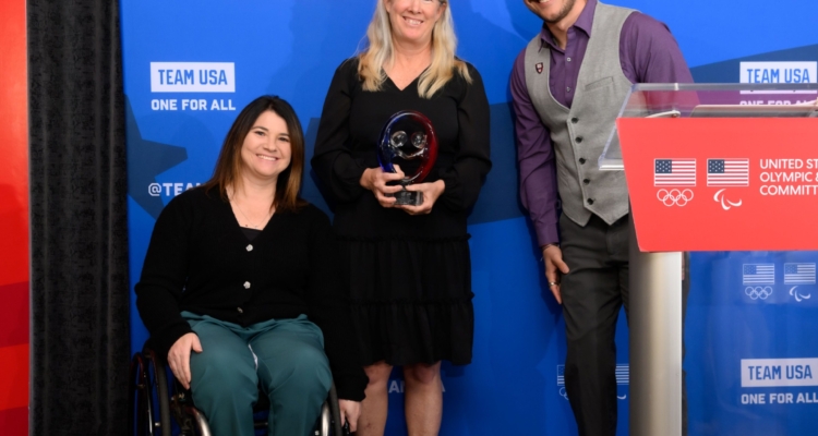 Paralympian Tyler “TC” Carter presenting the U.S. Olympic and Paralympic Committee’s 2024 Rings of Gold Award to Move United’s competitions manager Jessie Cloy and Paralympic medalist, and director of competitions Susan Rossi.