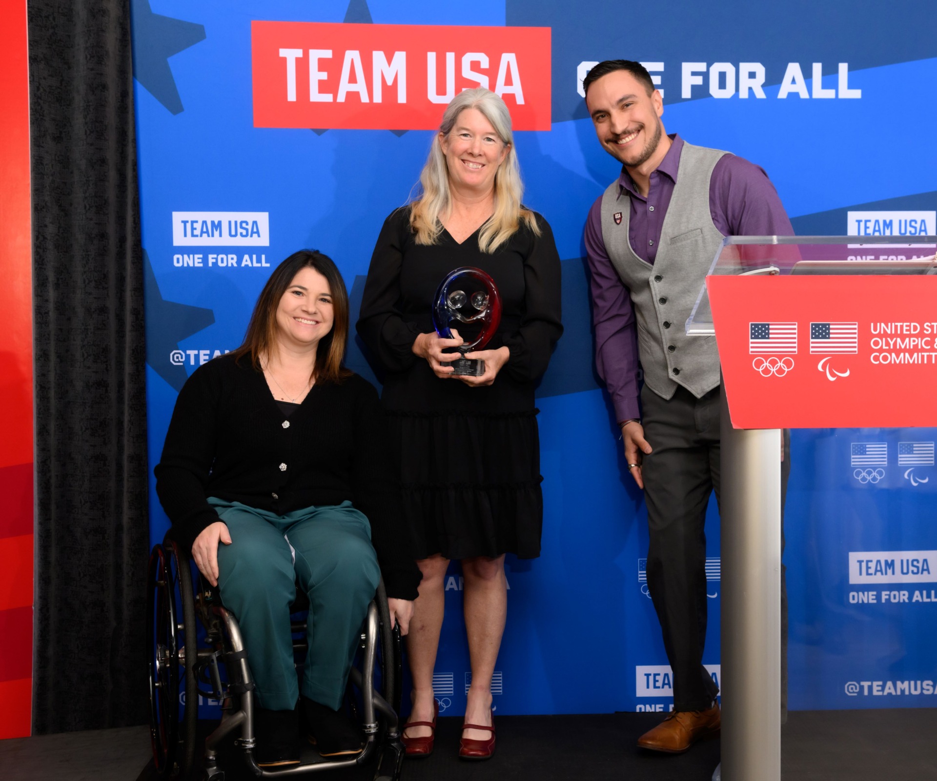 Paralympian Tyler “TC” Carter presenting the U.S. Olympic and Paralympic Committee’s 2024 Rings of Gold Award to Move United’s competitions manager Jessie Cloy and Paralympic medalist, and director of competitions Susan Rossi.