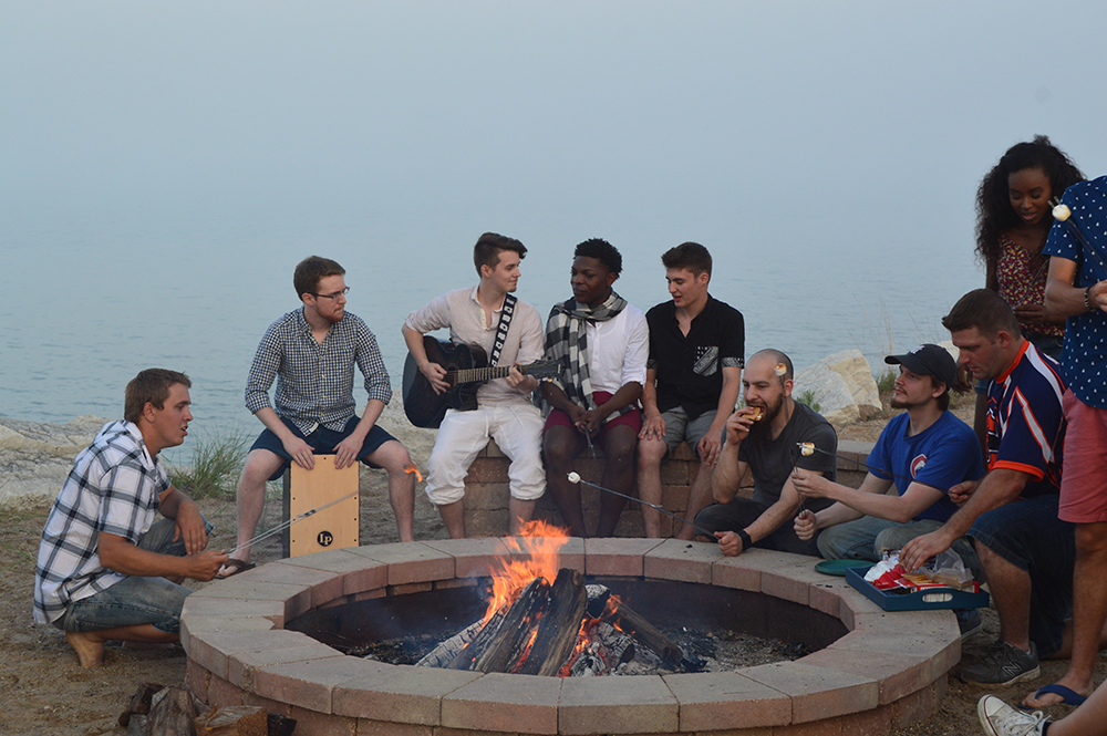 A group of people sit around a campfire in Lake County, Illinois