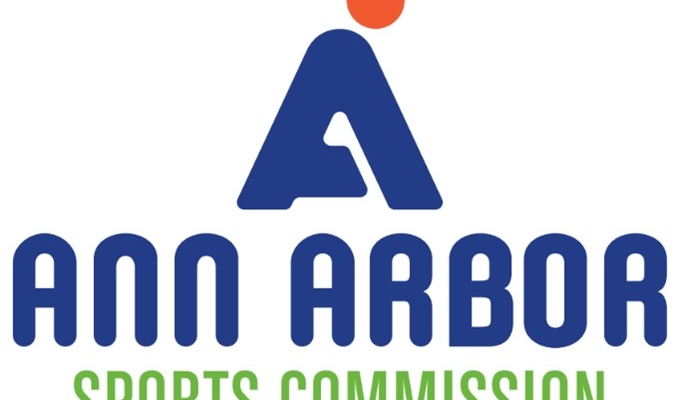 Ann Arbor Sports Commission logo with the words “Ann Arbor” in dark blue and “Sports Commission” in green.