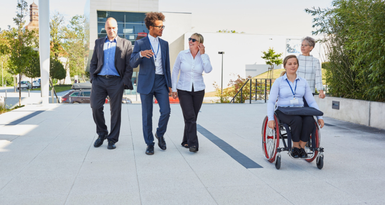 Business people from the multicultural business team with a colleague in a wheelchair