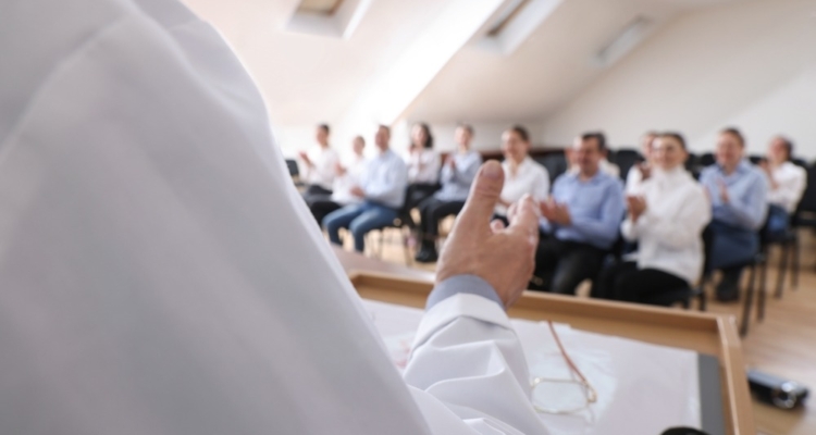 Doctor giving lecture during medical conference in meeting room