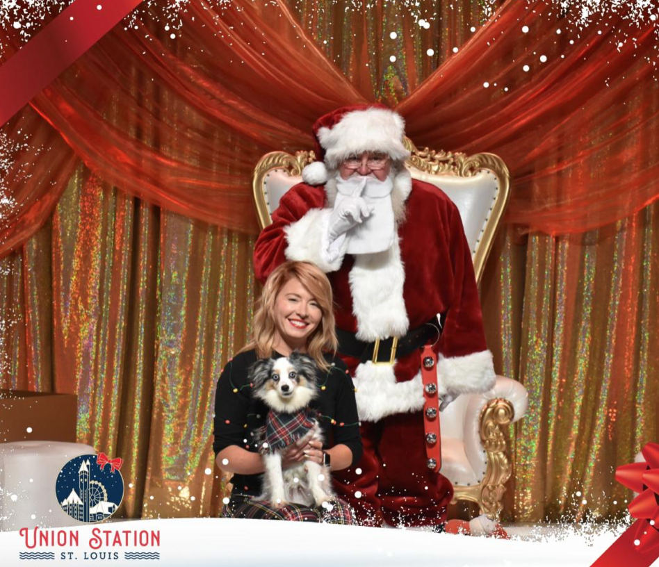 Paw meets Klaus! Puppy posing with Santa Claus at St. Louis Union