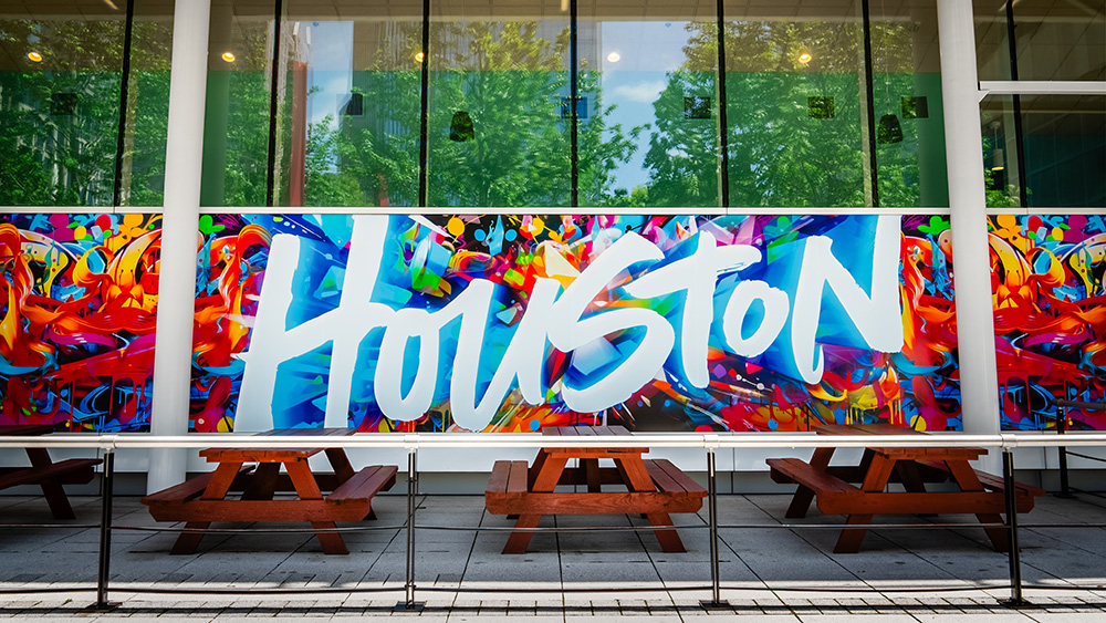 houston mural behind several picnic tables