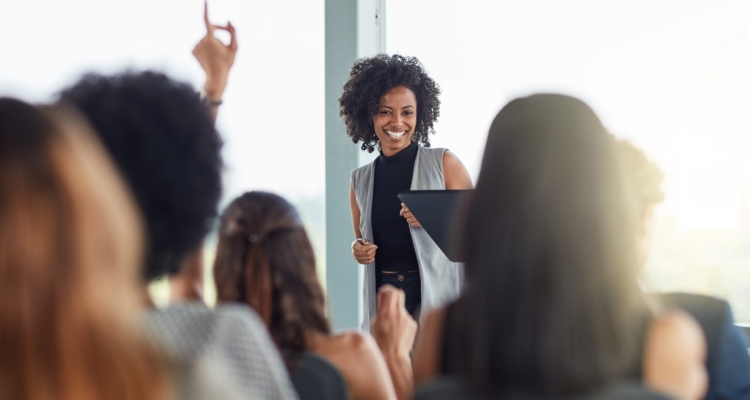 Businesswoman smiling in seminar in front of other women