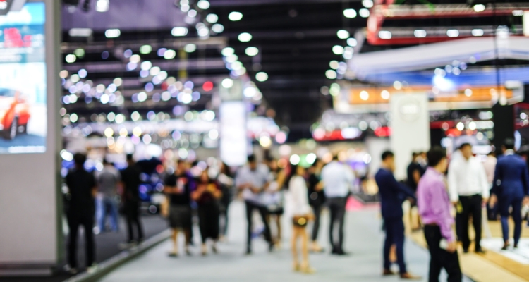 Abstract blurred background image with light of crowd people at cars exhibition show