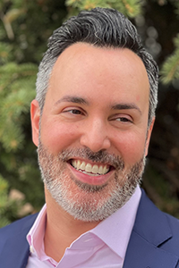 Smiling man with gray and black hair