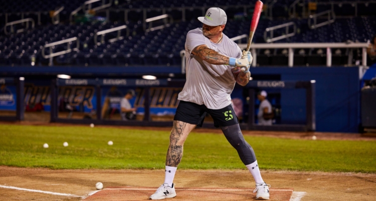 A close-up of someone hitting a ball with a bat on a field