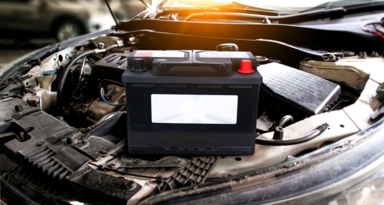 Car battery with blank white sign , battery placed on engine compartment for car electronic system , Car maintenance concept